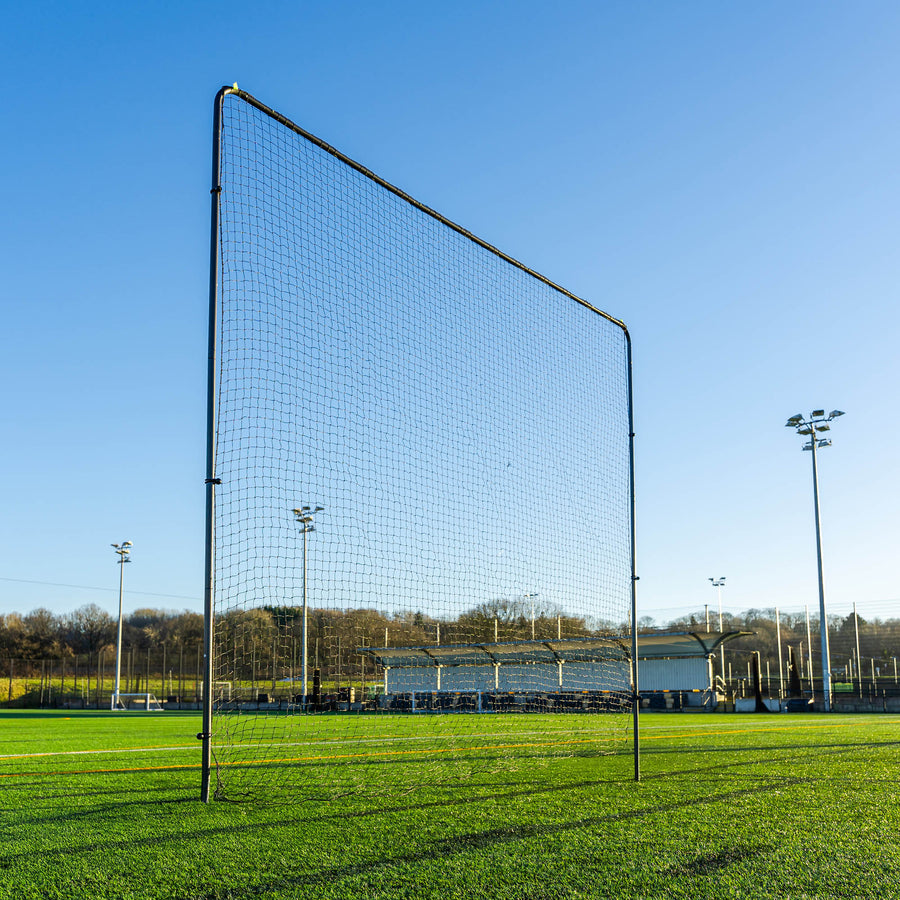 football barrier net on a grass field with clear blue sky