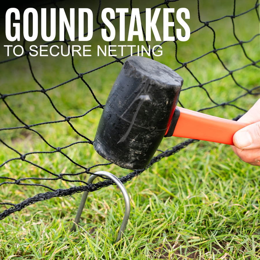 Hammering a ground stake into the grass to secure netting.