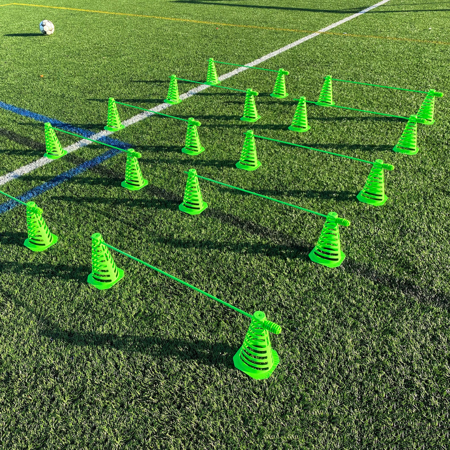 Green 9" collapsible cones and agility poles set out as rows of hurdles on an artificial pitch.
