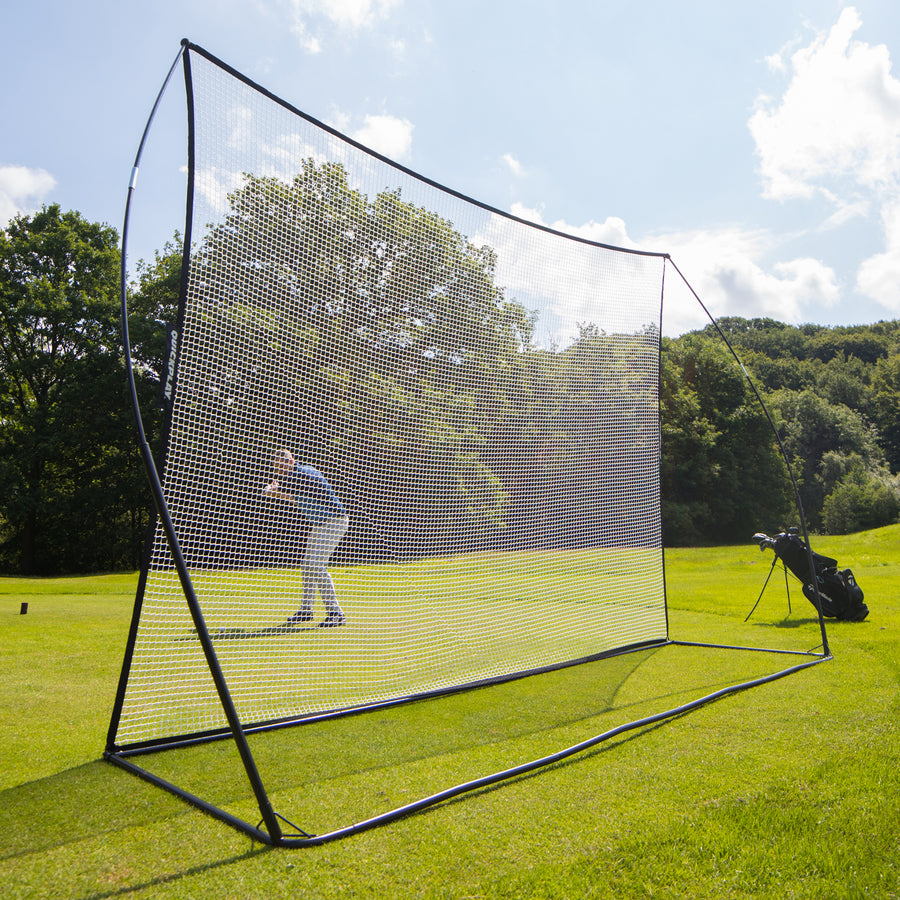 MEGA NET Golf Hitting Net 12x9' on a fairway seen from the front, with a golfer visible through the white net.