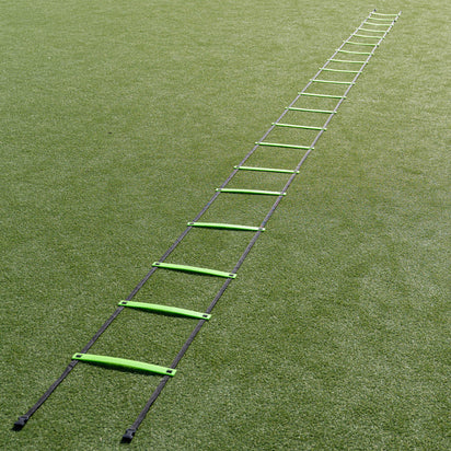 Green agility ladder on a grass field