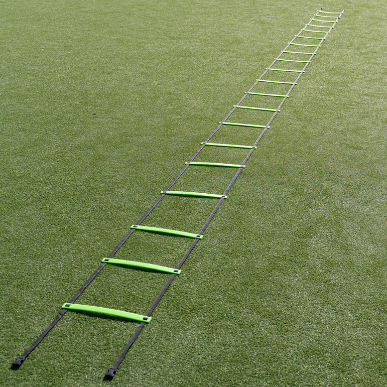 Green agility ladder on a grass field