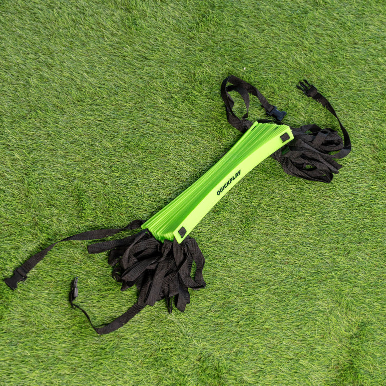 Green training aid with black straps on a grassy background