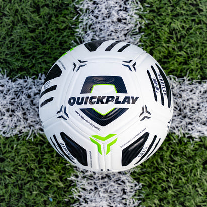 White football with black and green accents on a grass field, featuring the brand 'Quickplay'.