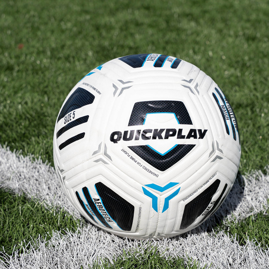 White football with blue and black accents on a grass field, featuring the brand 'Quickplay'.