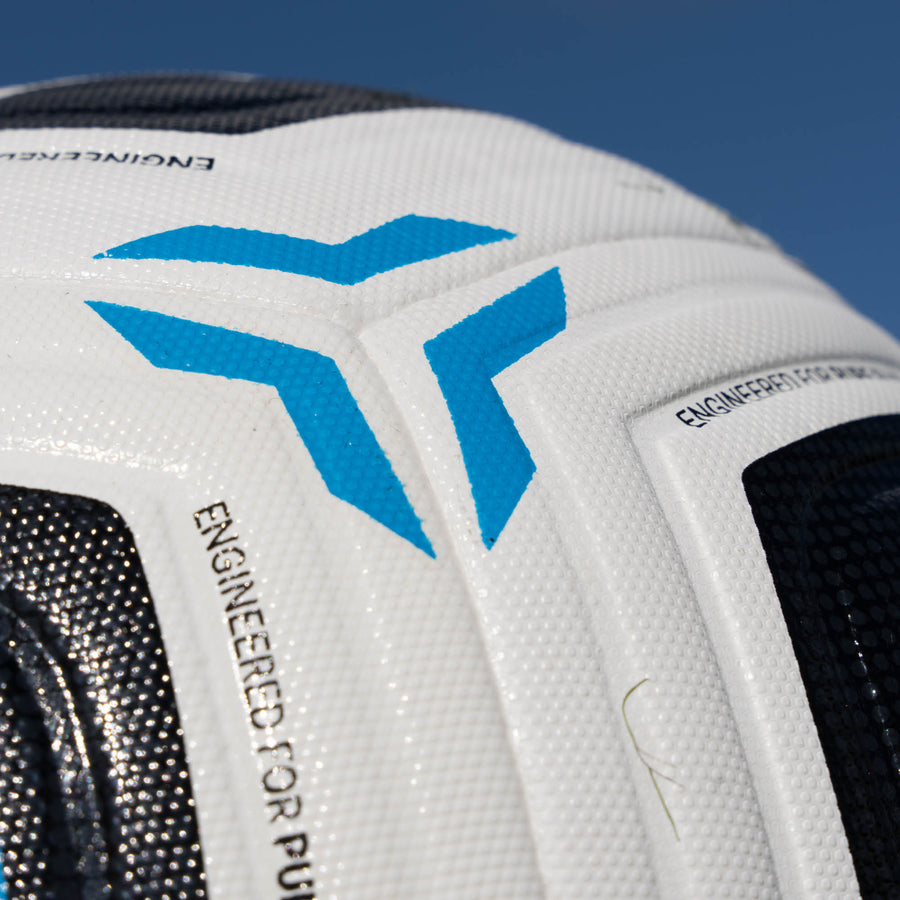 Close-up of a white football with blue logo and text on a blue background