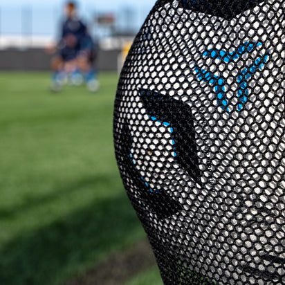 Close-up of a football bag on a blurred sports field background