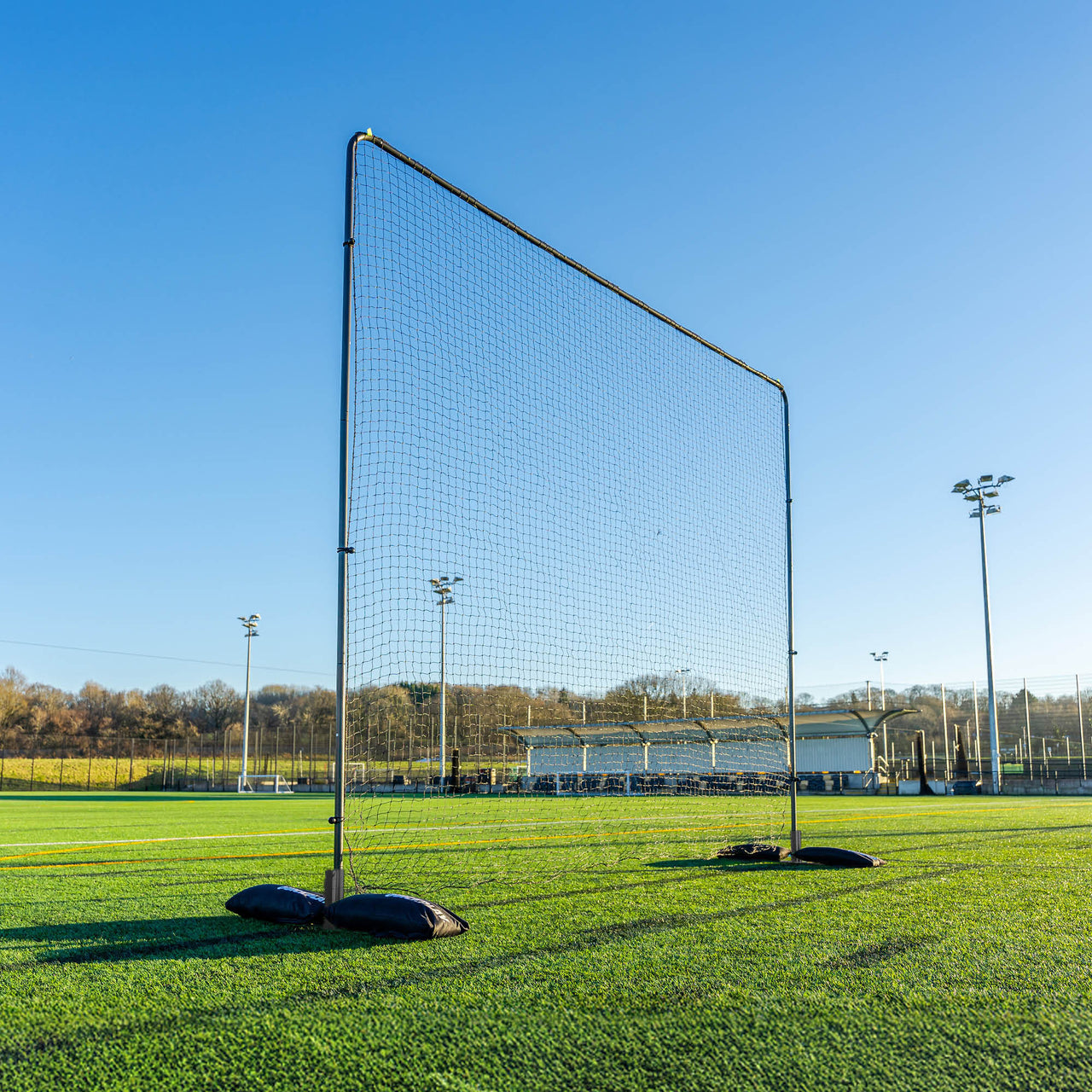 Large barrier net on a sports field with clear blue sky