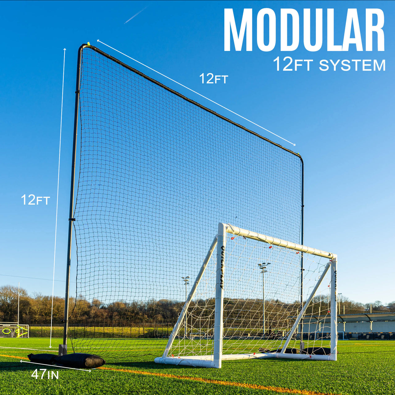 Modular 12ft barrier net system with a goal on a field with clear blue sky