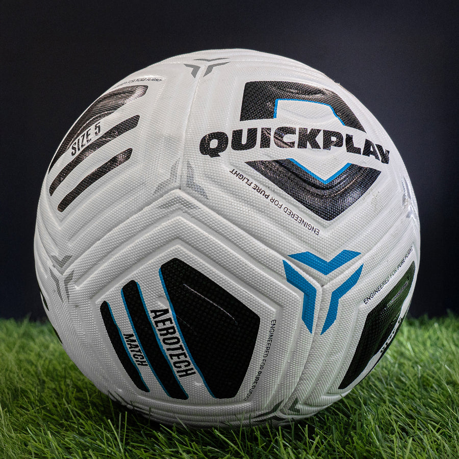 White match football with black and blue branding on grass