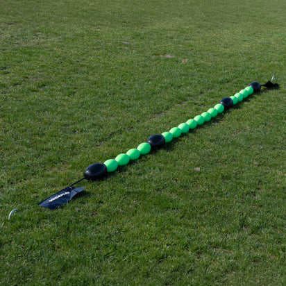 Long line of a green goalkeeper deflection line on grass