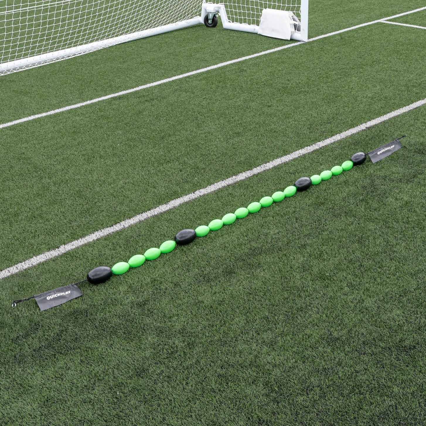 Long line of a green goalkeeper deflection line on grass