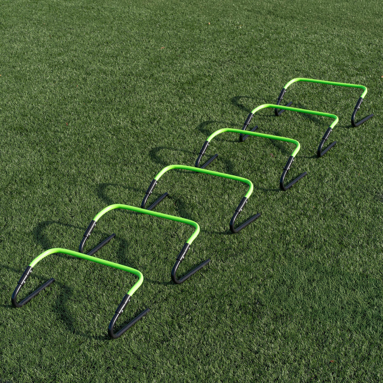 Set of green and black hurdles on a grass field