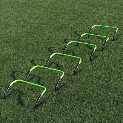 Set of green and black hurdles on a grass field