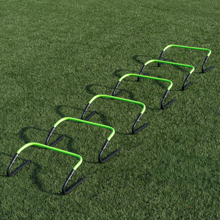 Set of green and black hurdles on a grass field
