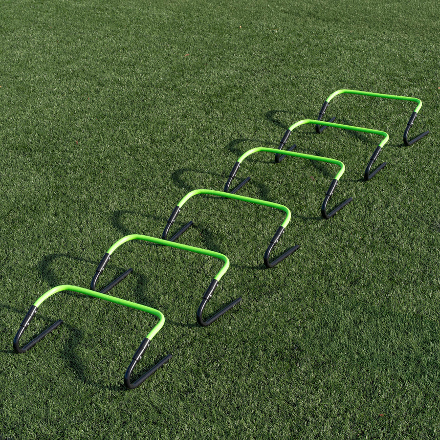 Set of green and black hurdles on a grass field