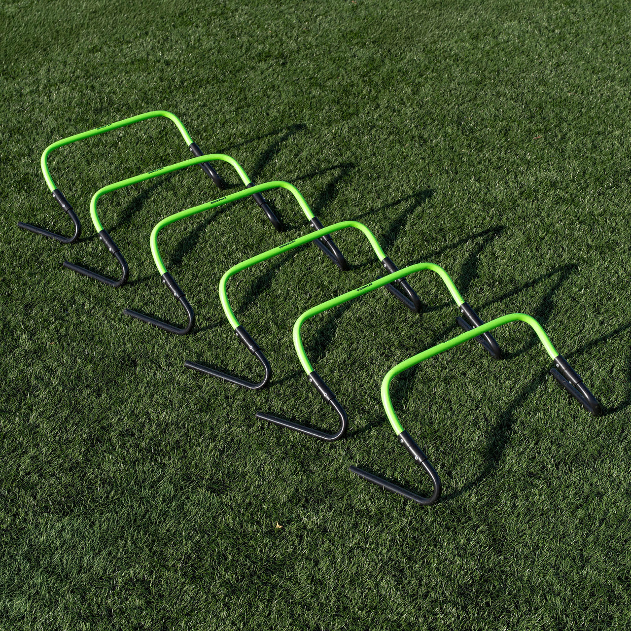 Set of green and black hurdles on a grass field