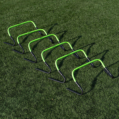 Set of green and black hurdles on a grass field