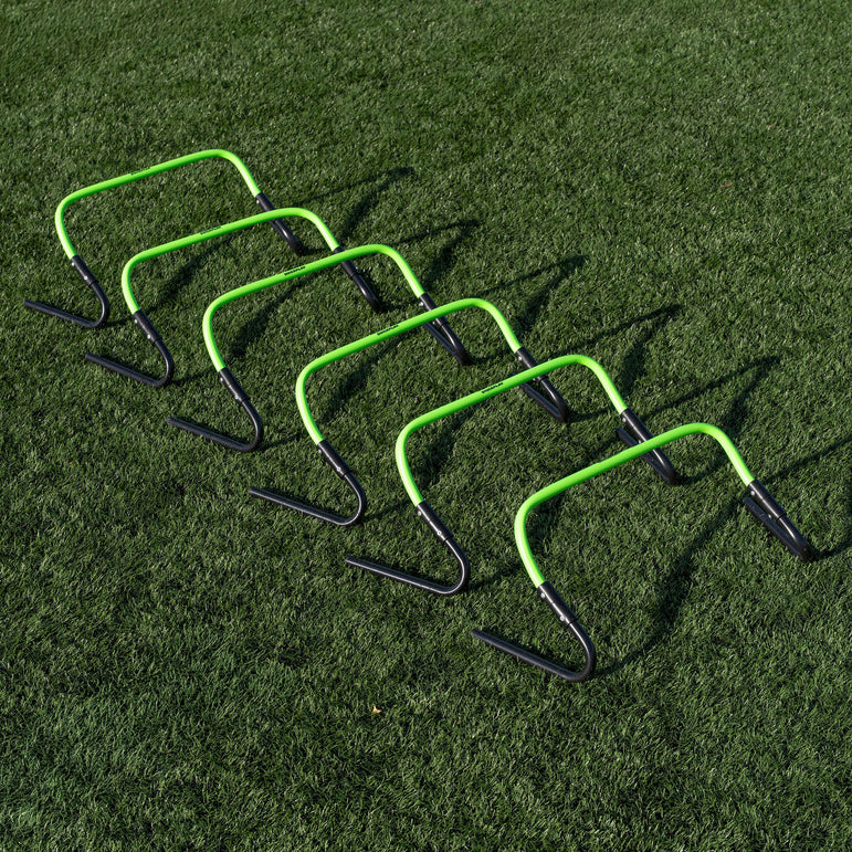 Set of green and black hurdles on a grass field