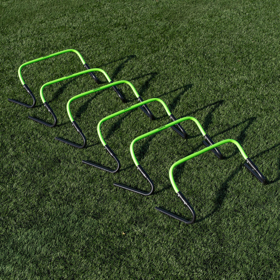 Set of green and black hurdles on a grass field