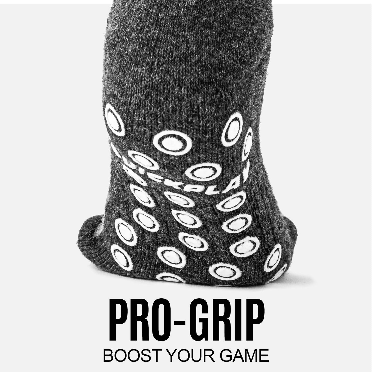 Close-up of the white grip dots on the sole of a grey QUICKPLAY Grip Sock, with the text "Pro-grip".