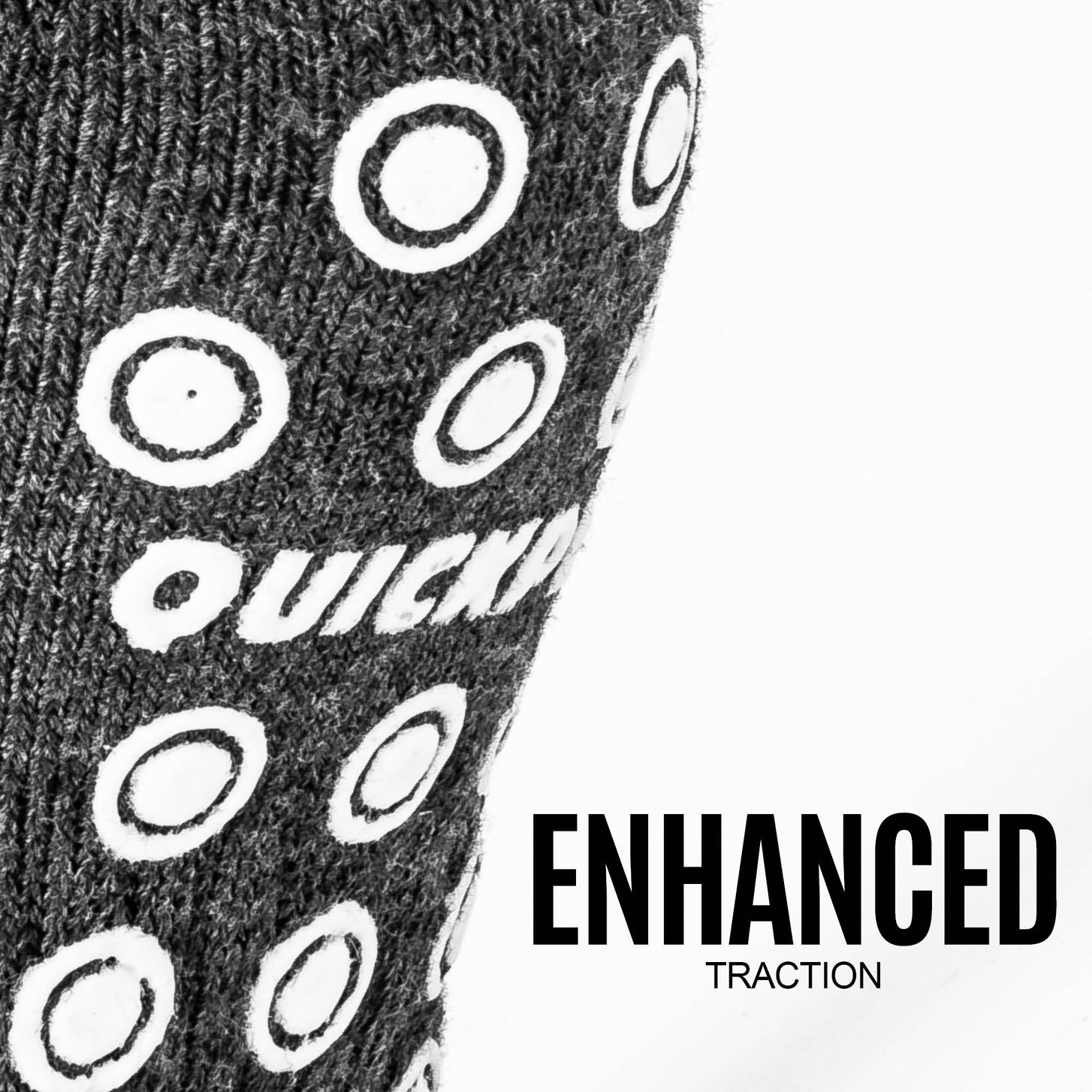Close-up of the ring-shaped grip dots and QUICKPLAY logo on a Grip Sock sole, with the text "Enhanced traction".