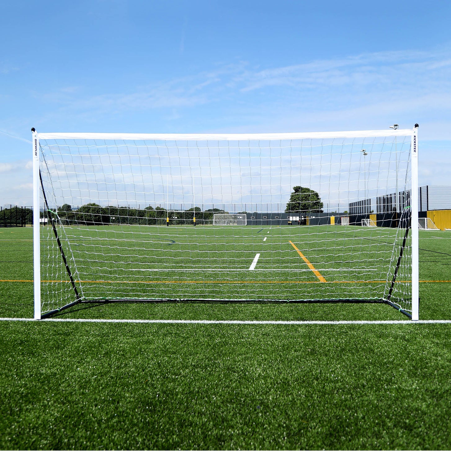 KICKSTER Elite Portable Football Goal 12x6' seen straight on, with a white frame and net on an artificial pitch.
