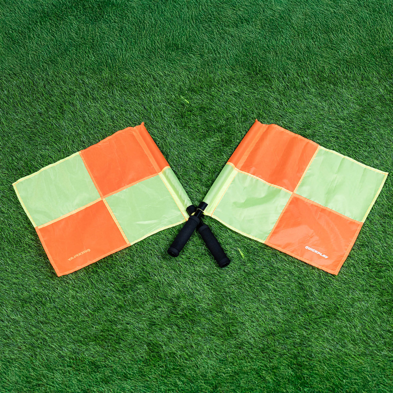 Two linesman flags on a green grass field