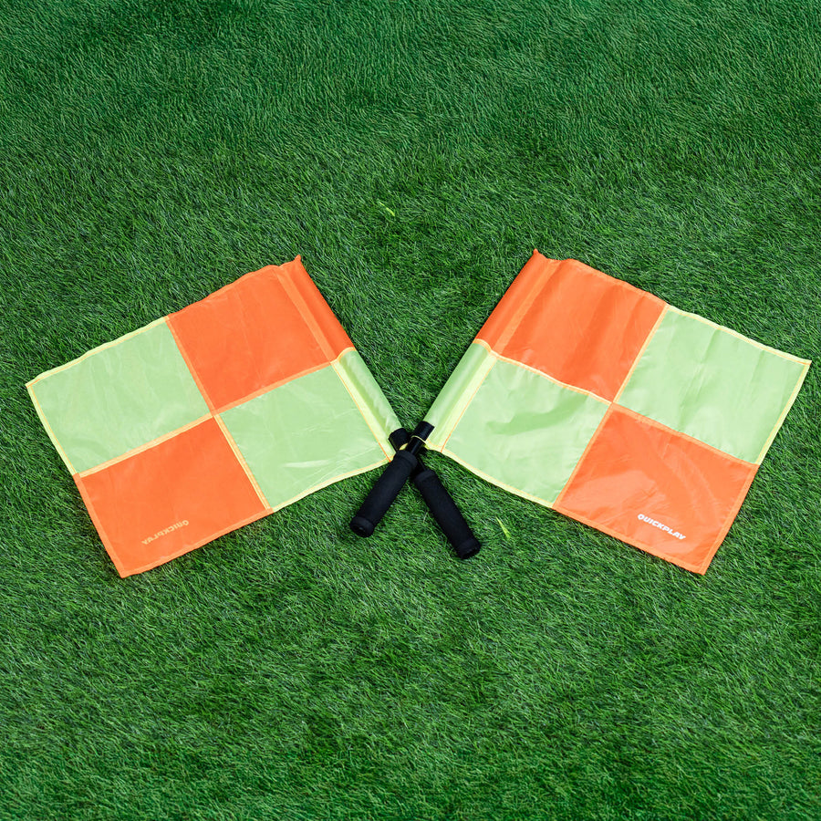 Two linesman flags on a green grass field
