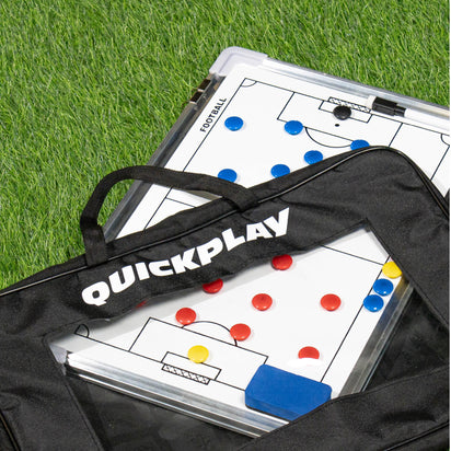 Coaching board with strategy diagrams on grass, featuring the brand 'Quickplay'.