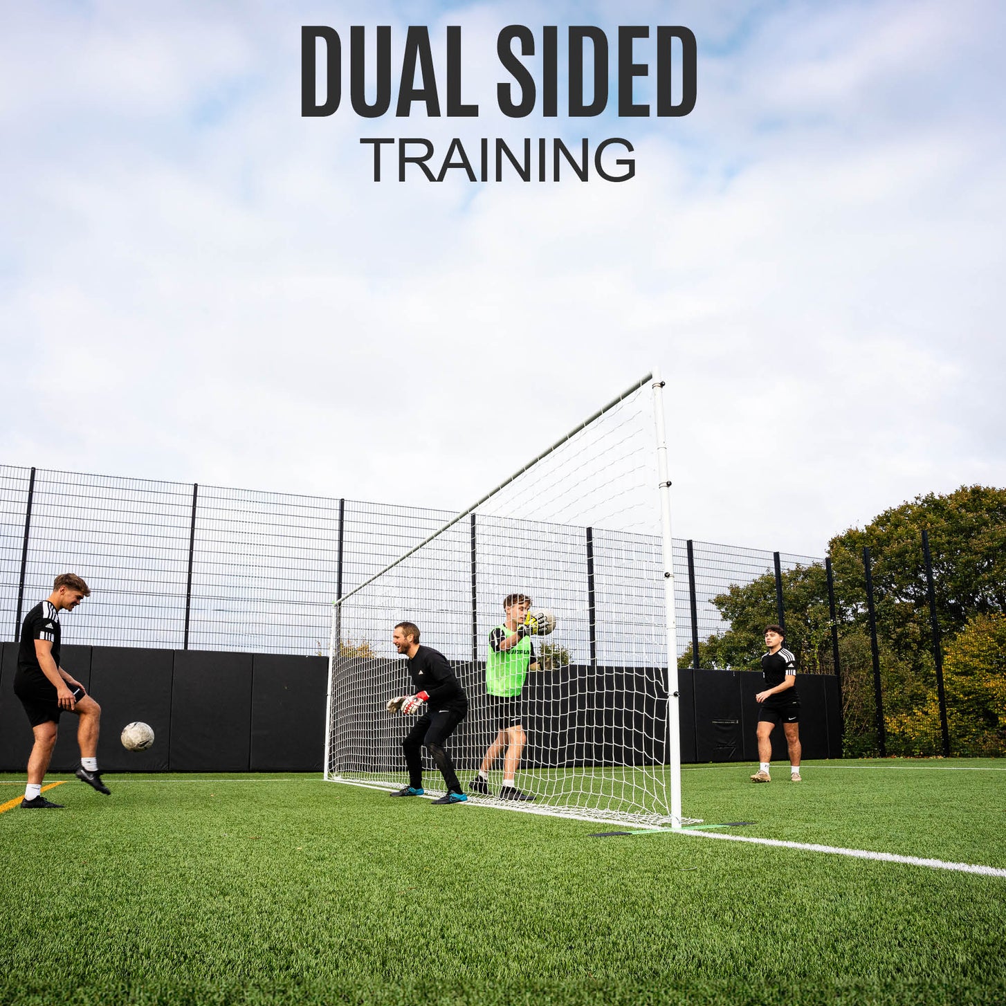 Two goalkeepers working on either side of the PRO ALU Training Frame 18.5x6.5' on an artificial pitch, with the text "Dual sided training".
