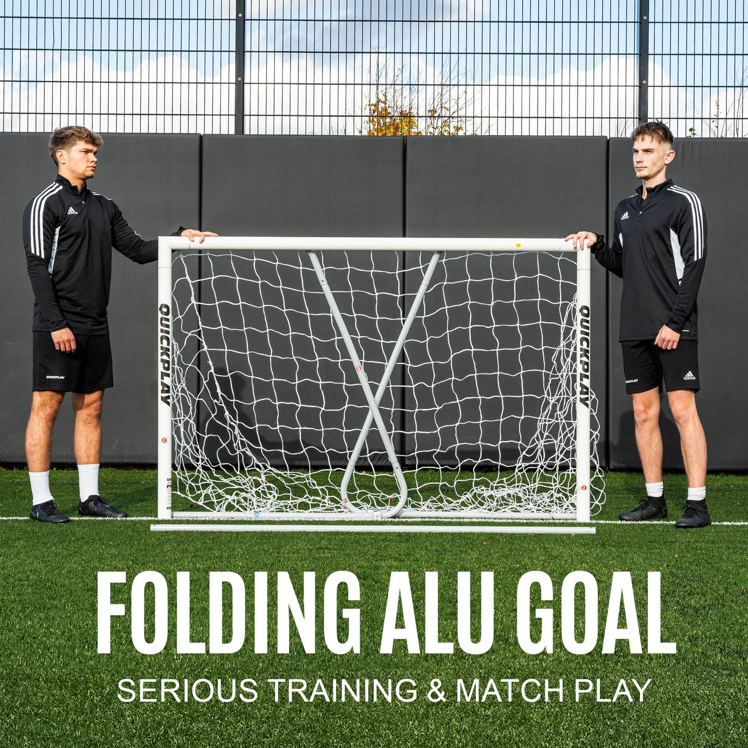 Two players either side of the PRO ALU Match60 8x5' goal with its folding rear frame, with the text "Folding alu goal".