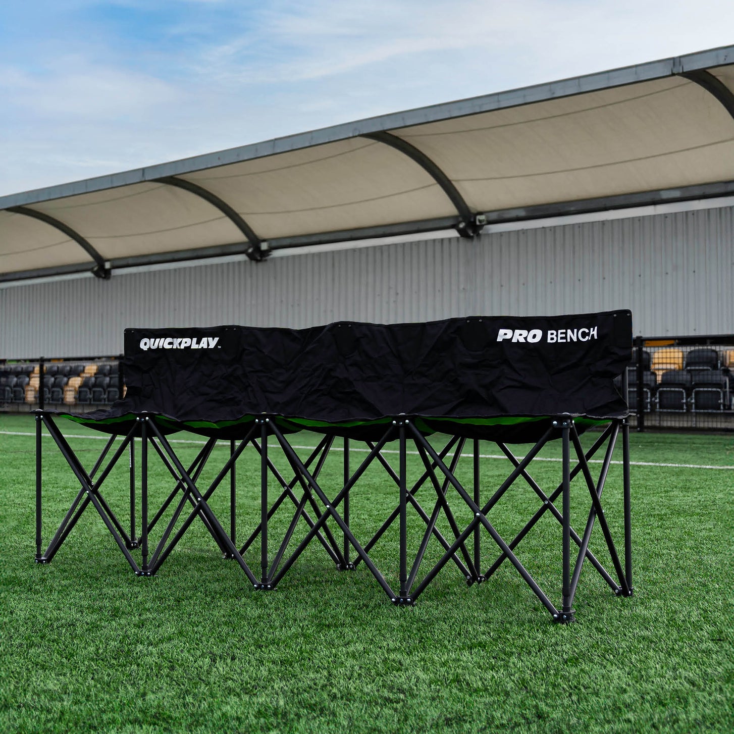 PRO Bench 4 seat subs bench set up on an artificial pitch in front of a covered stand.