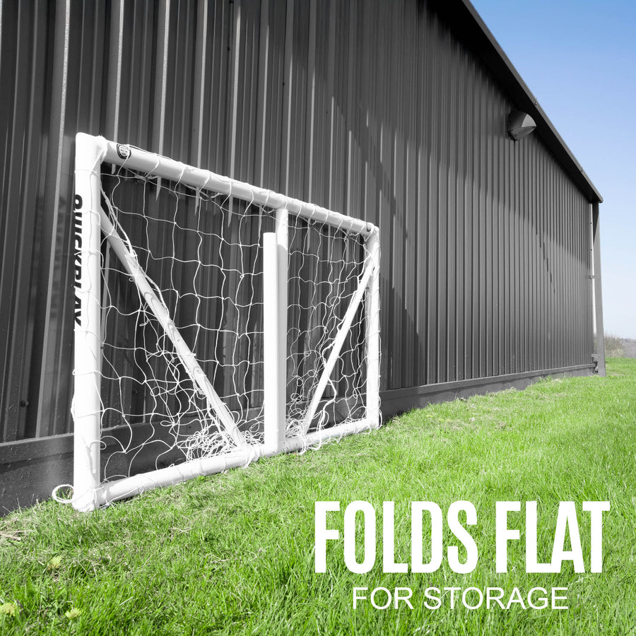Foldable soccer goal against a barn with 'Folds Flat for Storage' text.