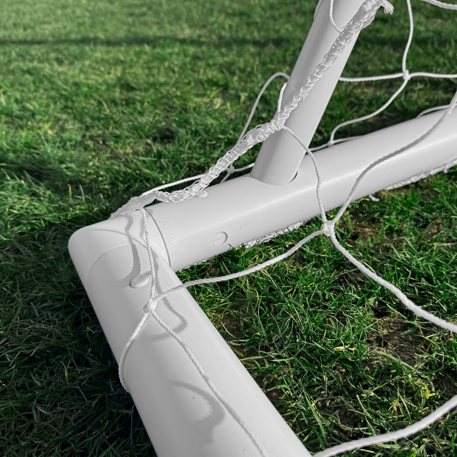White soccer goal on a grass field