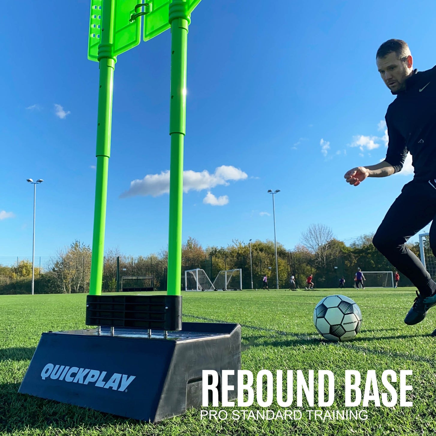 Player receiving a ball rebounding off a REPLAY Defender base on an artificial pitch, with the text "Rebound base".
