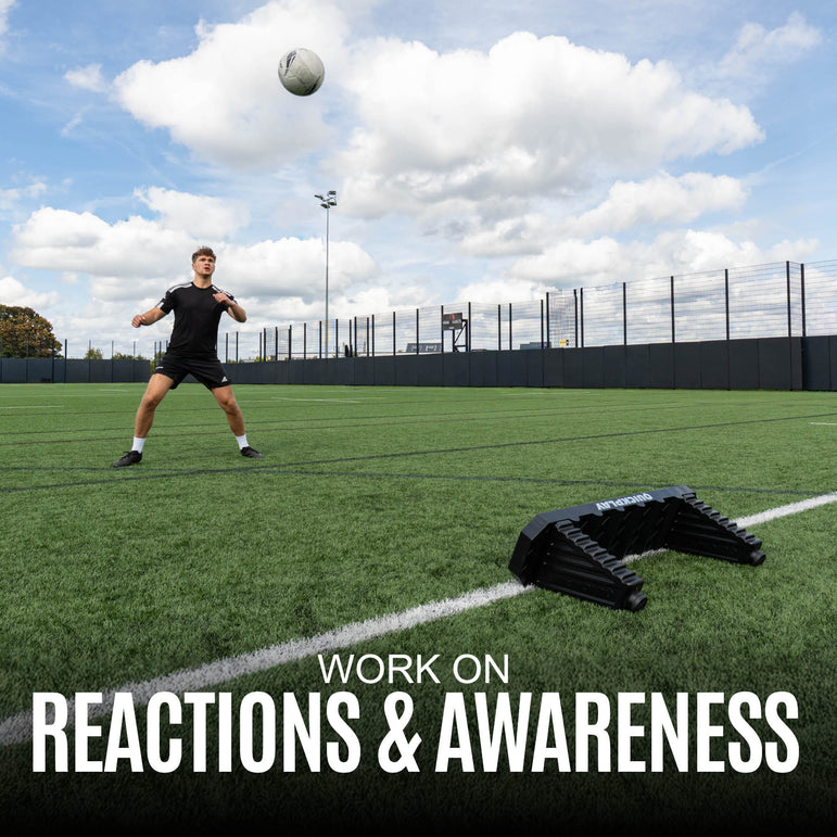 Person practicing soccer drills with a ball on a sports field, text 'Work on Reactions & Awareness' displayed.