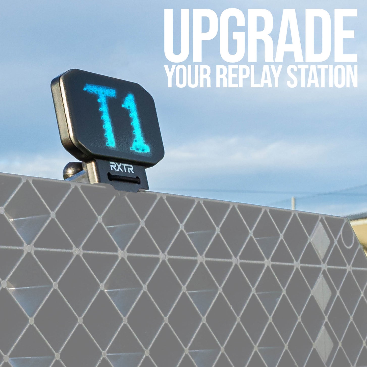 RXTR display with 'T1' on a geometric-patterned wall against a blue sky.