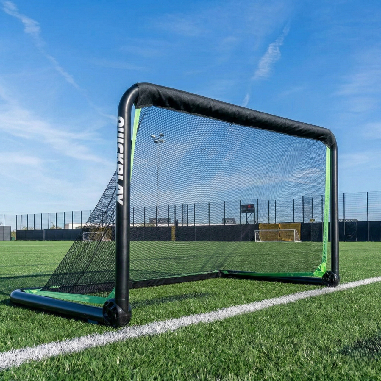 Portable rhino football goal on a grass field with a clear blue sky.