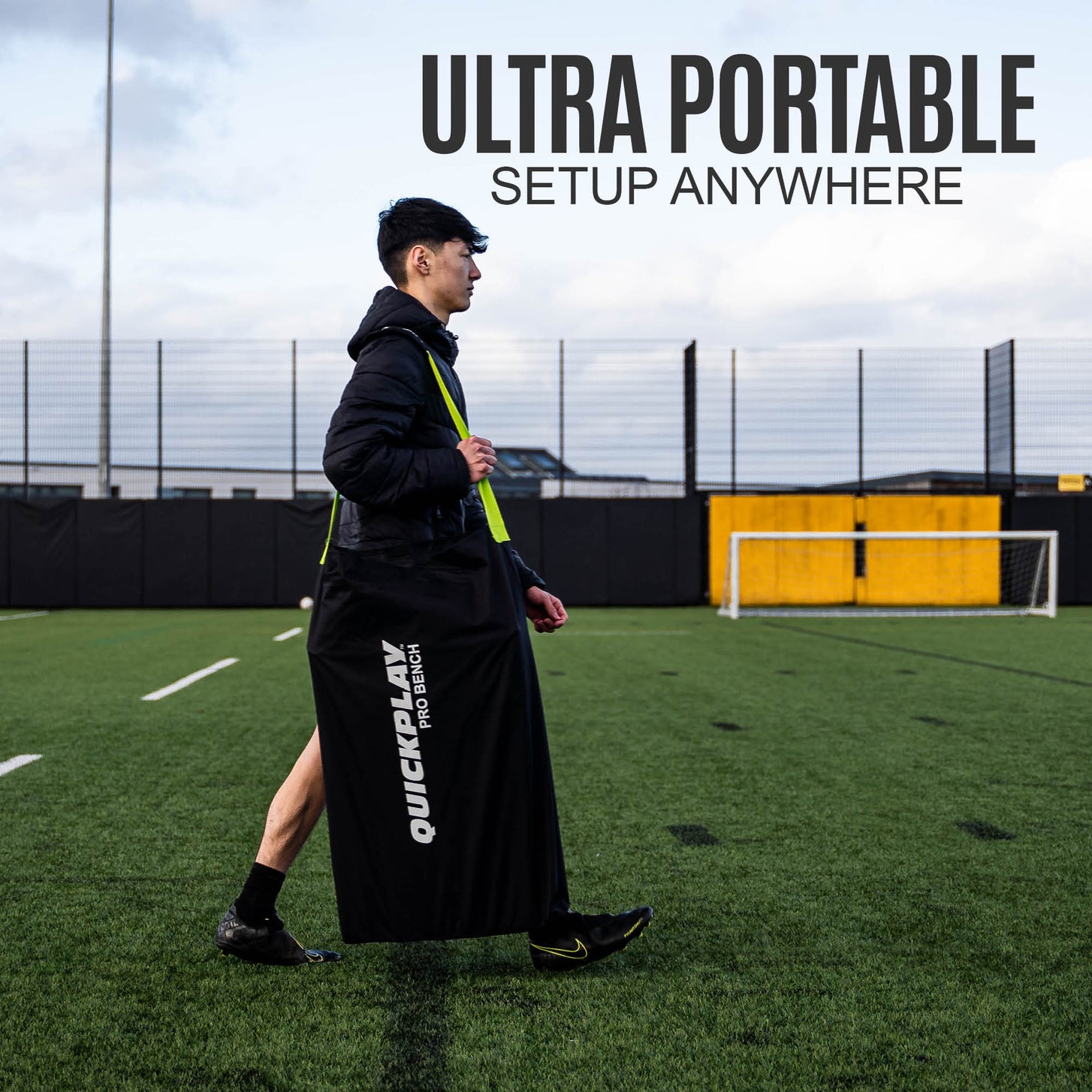 Man walking across a pitch carrying the PRO Bench in its black bag, with the text "Ultra portable, setup anywhere".