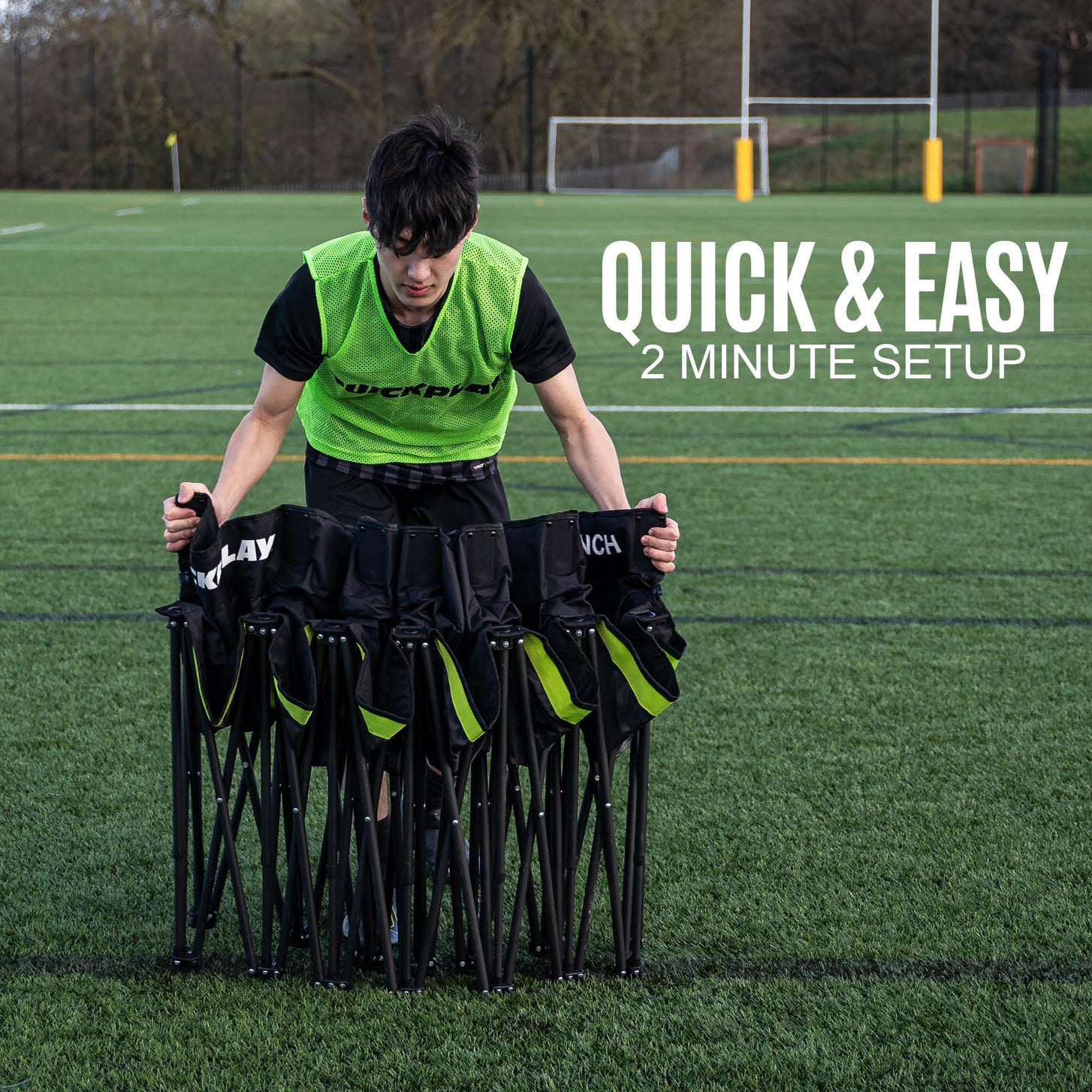 Young man in a bib unfolding the PRO Bench Shelter seats on an artificial pitch, with the text "Quick & easy".