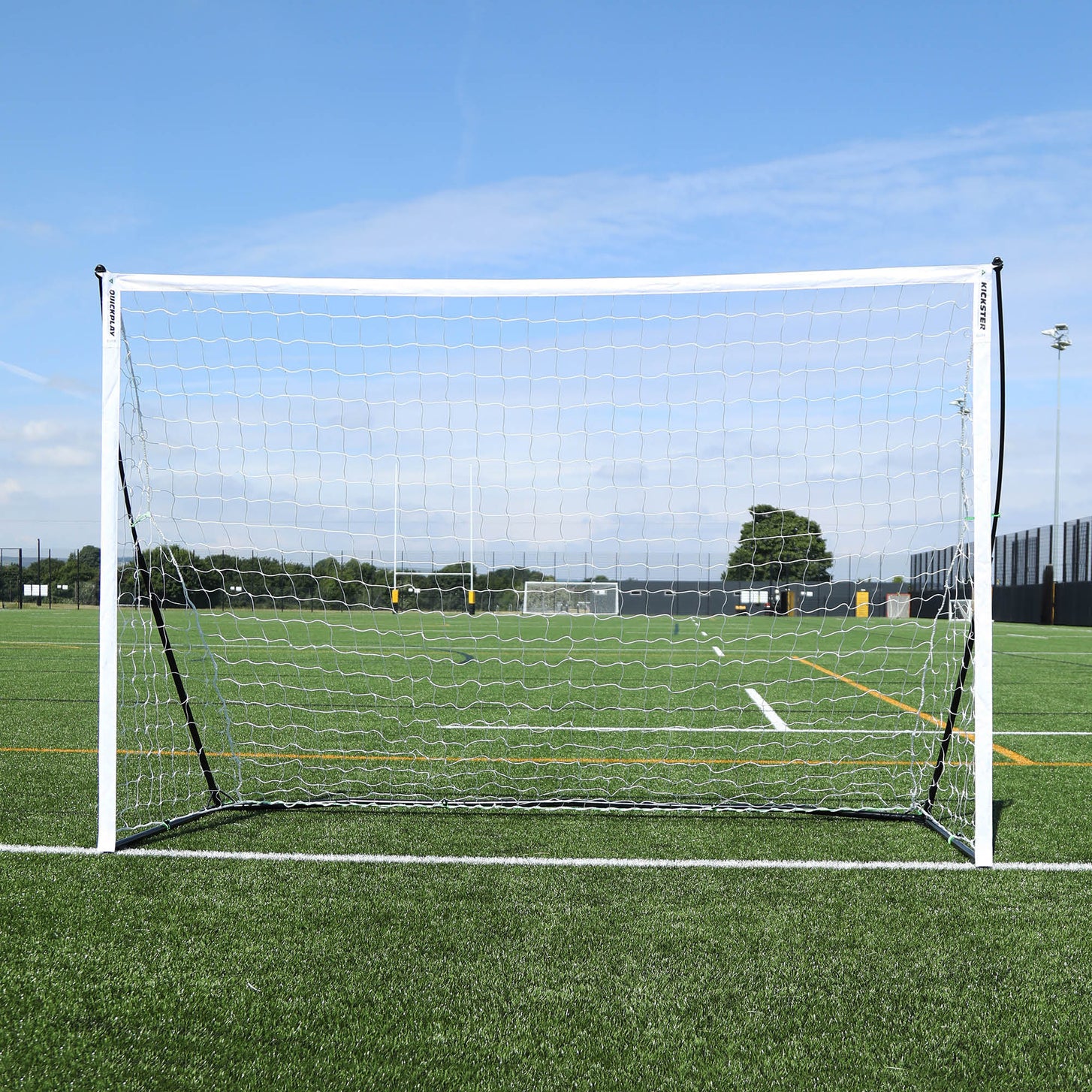 KICKSTER Elite Portable Futsal Goal 3x2m seen straight on, with a white frame and net on an artificial pitch.