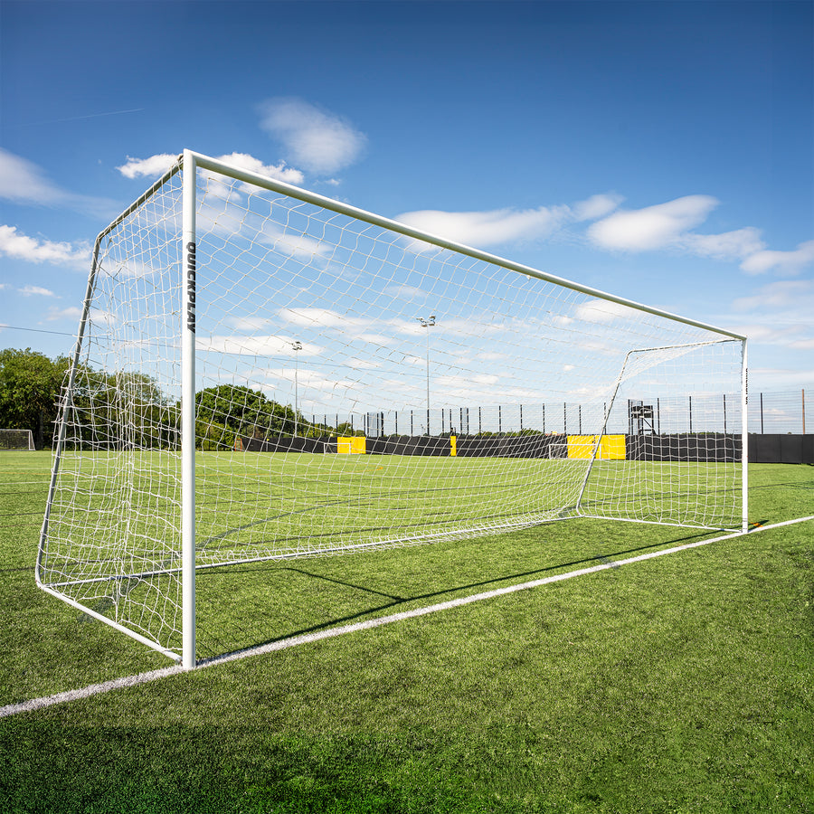 Pro ALU football goal on a grass field with a clear blue sky