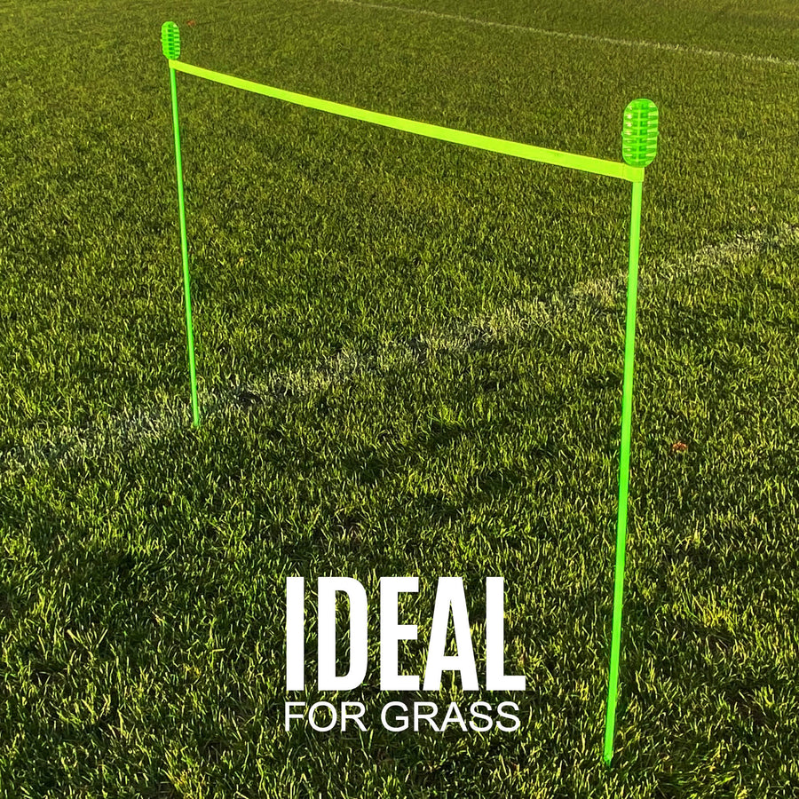 Two green PRO Speed & Agility Set poles standing in grass with a green band between them, with the text "Ideal for grass".
