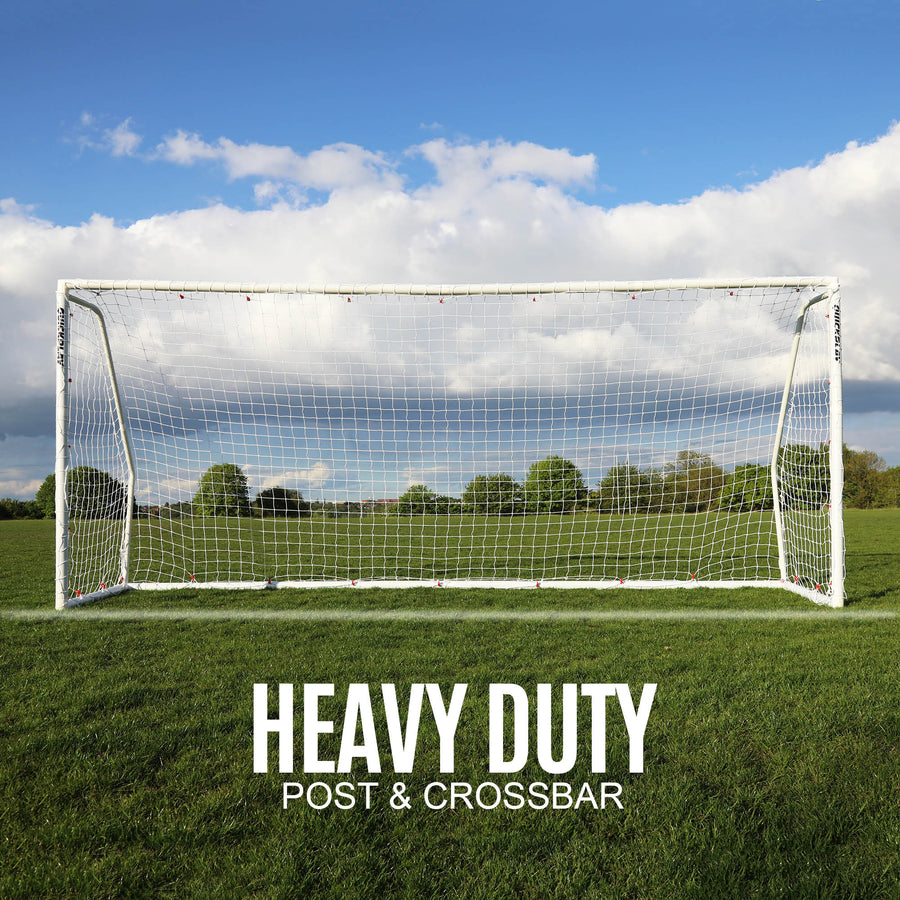 Q-FOLD Match 12x6' goal front view on grass with trees behind, with the text "Heavy duty post & crossbar".
