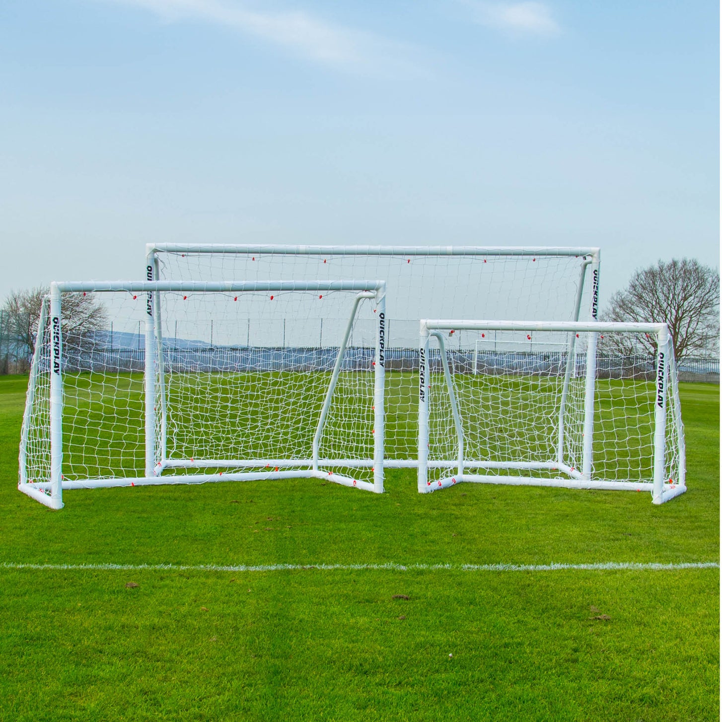Q-FOLD Match 12x6' shown with two other Q-FOLD Match goal sizes on a grass field.