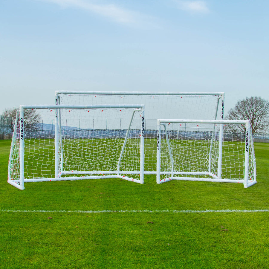 Q-FOLD Match 6x4' goal shown with two other white QUICKPLAY goals of different sizes on a grass pitch.