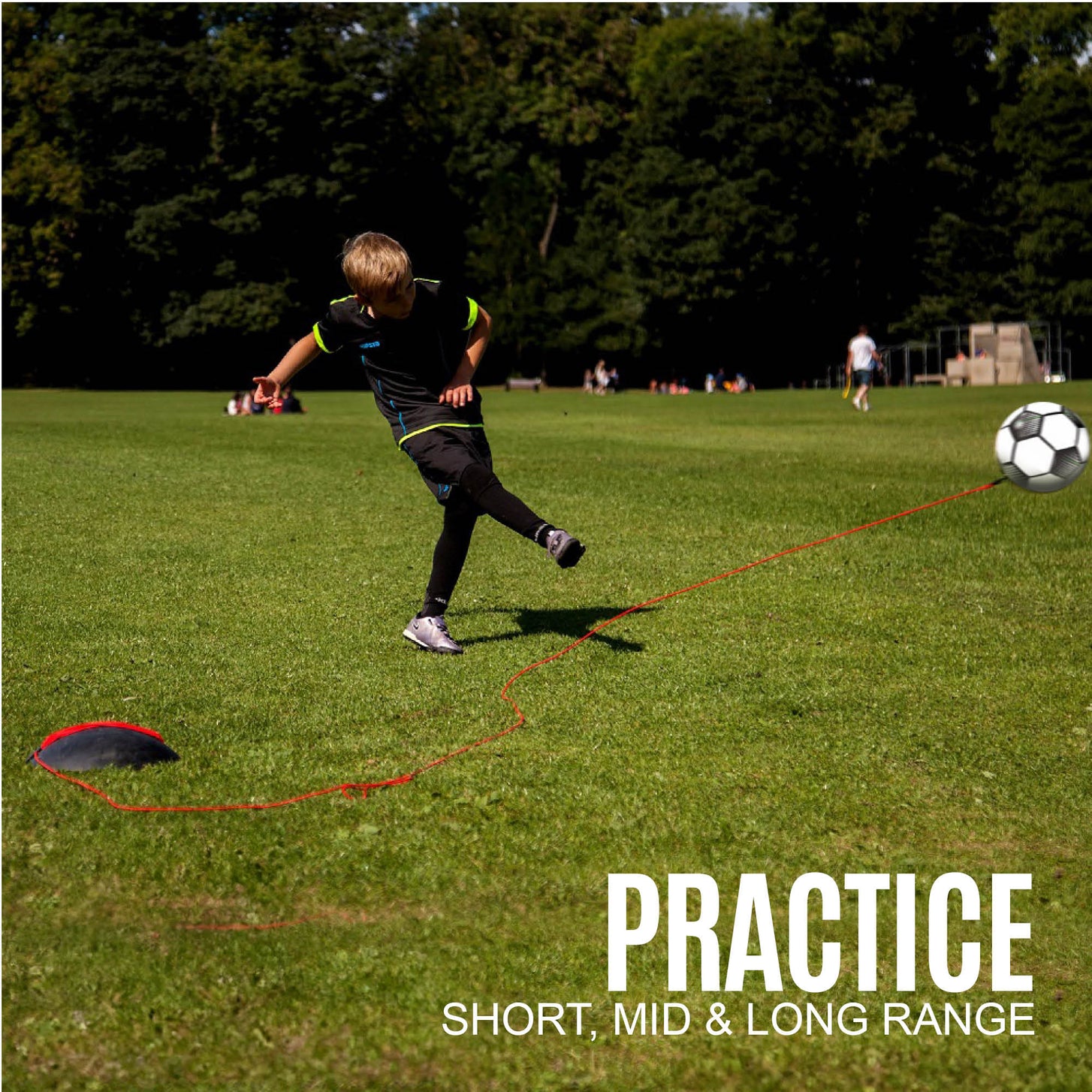 Boy striking the REPLAY Football Trainer Size 4 in a park, with the text "Practice short, mid & long range".