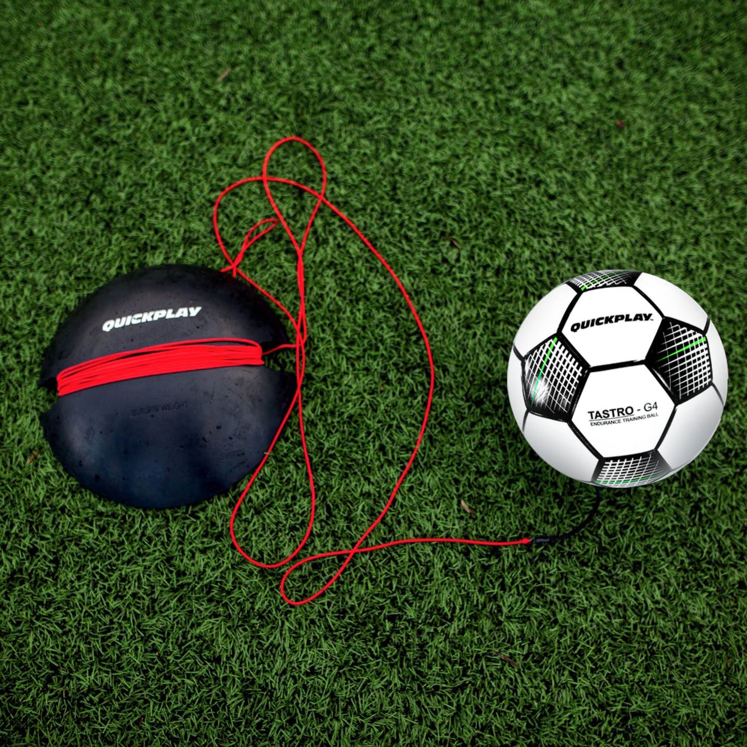 REPLAY Football Trainer Size 4 from above on artificial grass: ball, loose red cord and black QUICKPLAY base.