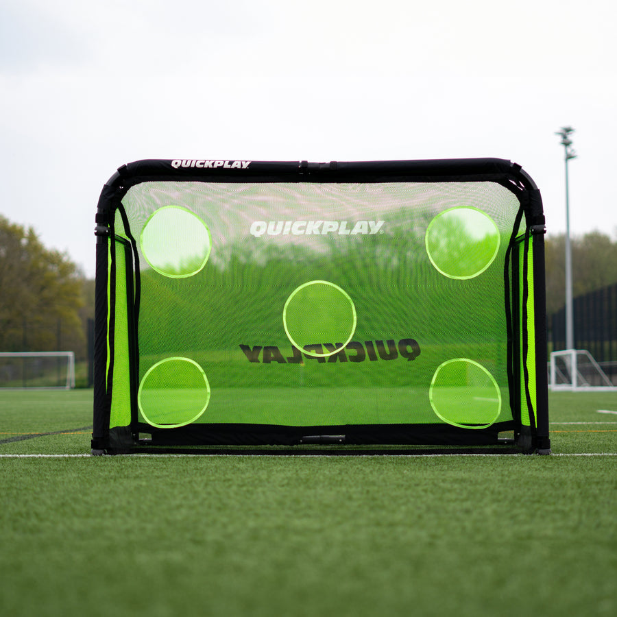 PRO ALU Training Target Net Lite 6x4' with five target holes, fitted to a black goal frame on an artificial pitch.